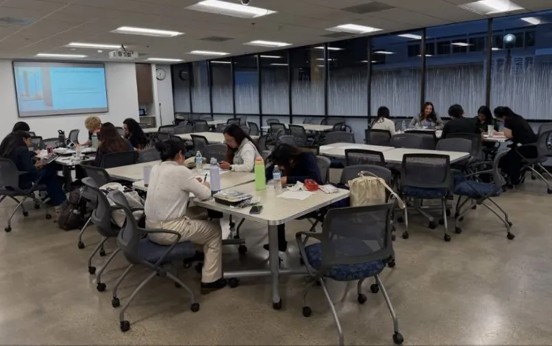 Participants working through exercises at tables during a workshop